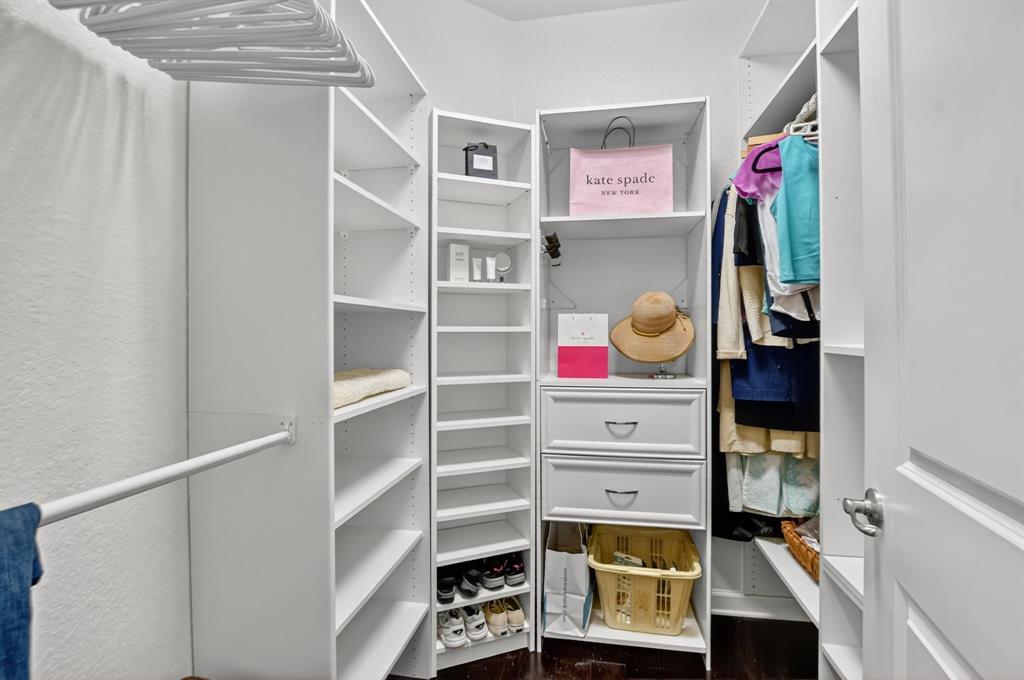 591 Northwest Library Commons Way Boca Raton, FL 33432 - Photo 50 of 75 a view of walk in closet with clothes and shoes