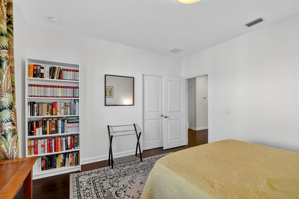 591 Northwest Library Commons Way Boca Raton, FL 33432 - Photo 56 of 75 a bedroom with a bed and a book shelf