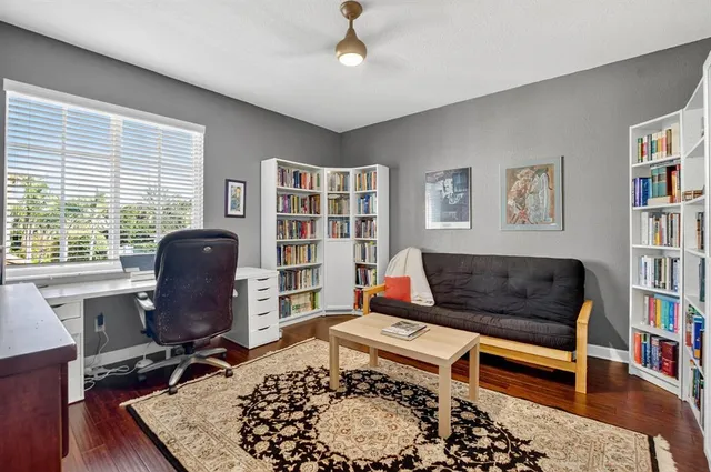 front view of a house with a yard and palm trees