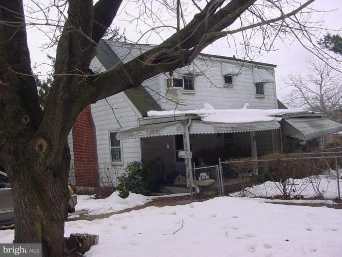8814 Liberty Road Randallstown, MD 21133 - Photo 3 of 5 a view of a house with a yard covered with snow