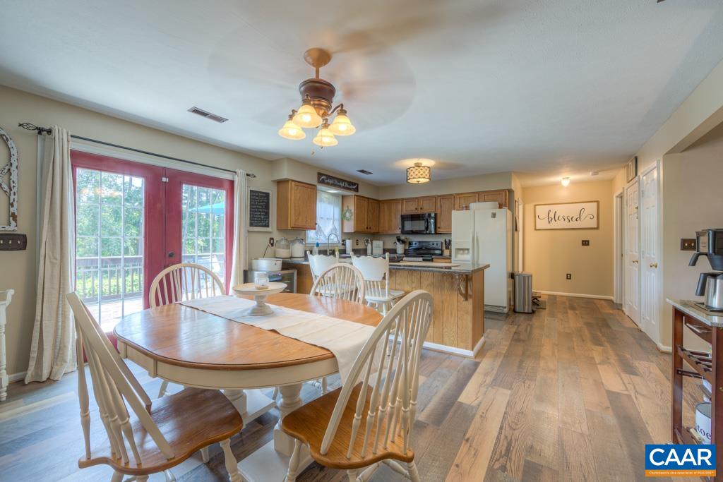 235 Spring Oaks Lane Ruckersville, VA 22968 - Photo 12 of 44 a dining room with furniture a window and wooden floor
