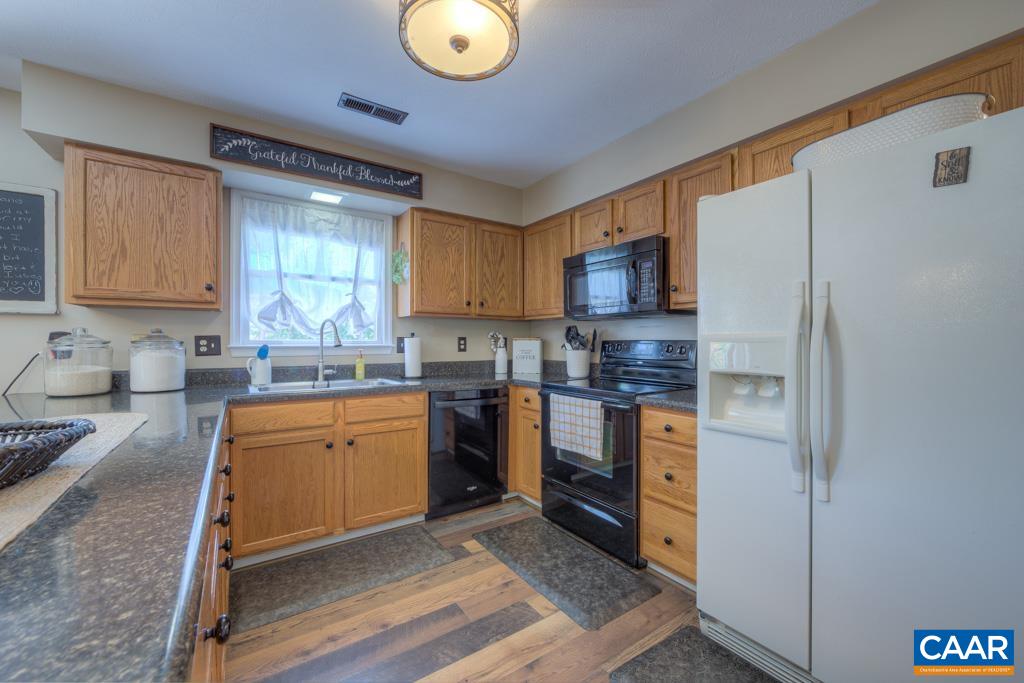 235 Spring Oaks Lane Ruckersville, VA 22968 - Photo 16 of 44 a kitchen with stainless steel appliances granite countertop a refrigerator sink and stove
