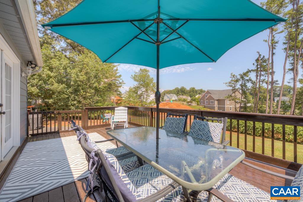 235 Spring Oaks Lane Ruckersville, VA 22968 - Photo 18 of 44 a balcony with wooden floor table and chairs