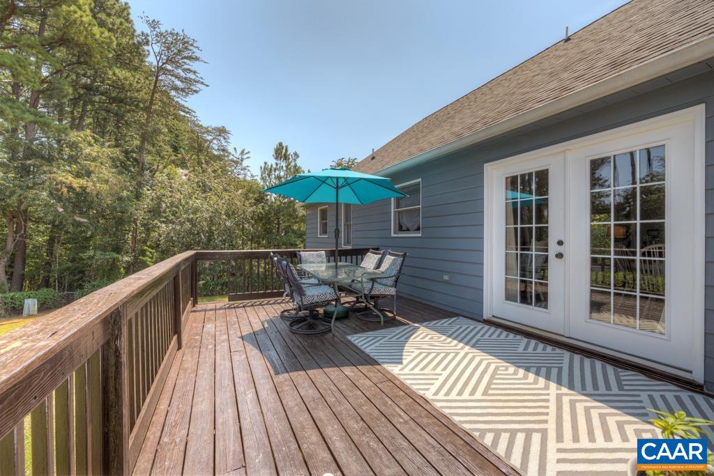 235 Spring Oaks Lane Ruckersville, VA 22968 - Photo 19 of 44 a balcony with wooden floor table and chairs