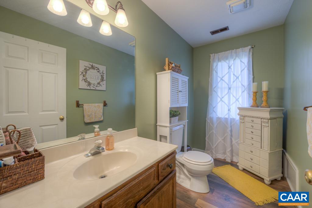 235 Spring Oaks Lane Ruckersville, VA 22968 - Photo 24 of 44 a bathroom with a granite countertop sink toilet and shower