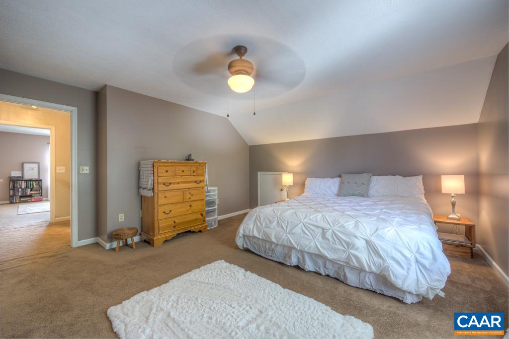 235 Spring Oaks Lane Ruckersville, VA 22968 - Photo 27 of 44 a bedroom with a bed and a lamp