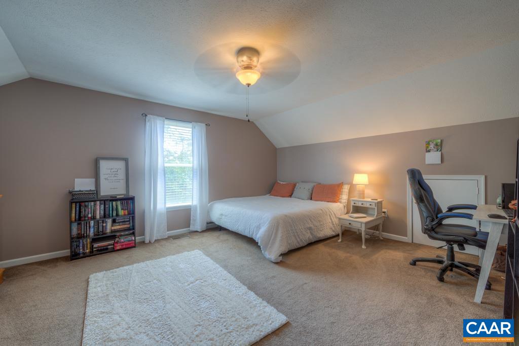 235 Spring Oaks Lane Ruckersville, VA 22968 - Photo 29 of 44 a bedroom with a bed and a chandelier