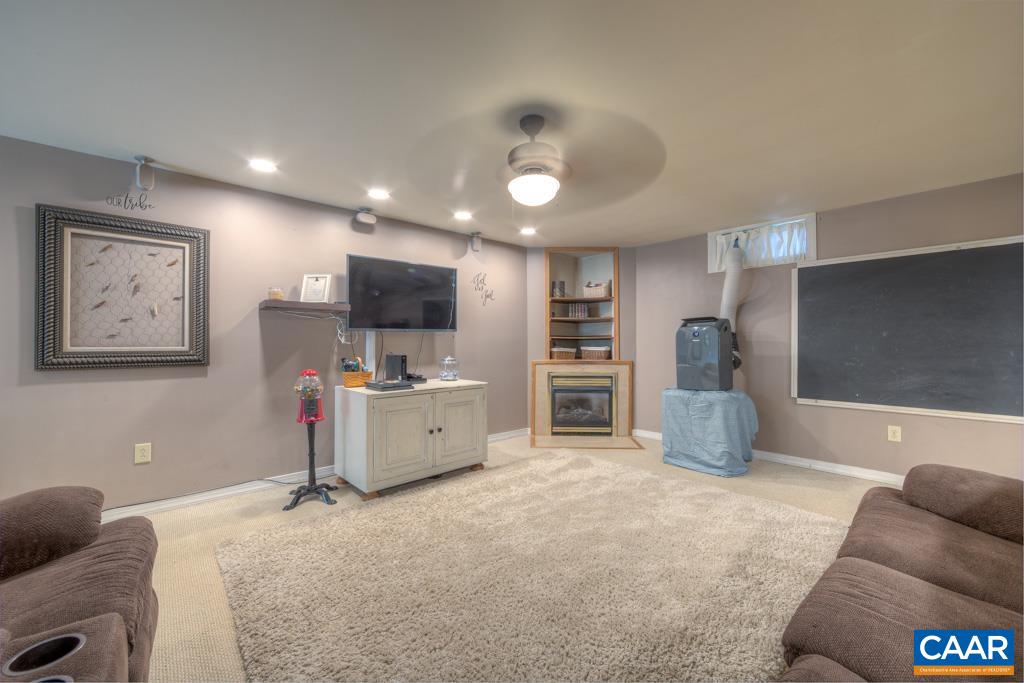 235 Spring Oaks Lane Ruckersville, VA 22968 - Photo 36 of 44 a large bedroom with a large bed and furniture