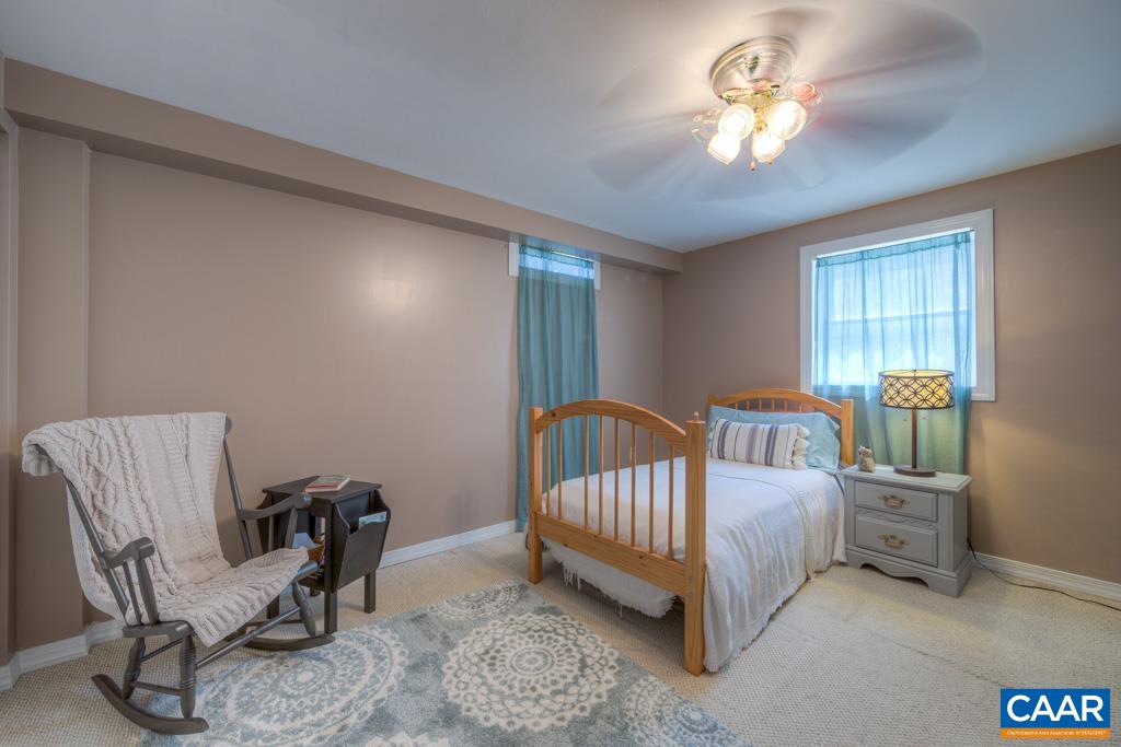 235 Spring Oaks Lane Ruckersville, VA 22968 - Photo 39 of 44 a bed room with a bed and a chair