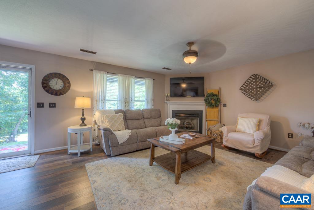 235 Spring Oaks Lane Ruckersville, VA 22968 - Photo 8 of 44 a living room with furniture and a wooden floor
