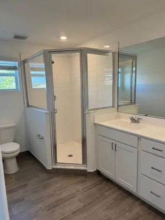 a bathroom with a double vanity sink and mirror