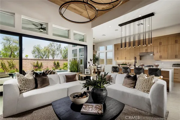 a living room with furniture a rug and a large window