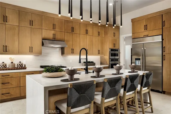 a kitchen with appliances a sink and cabinets