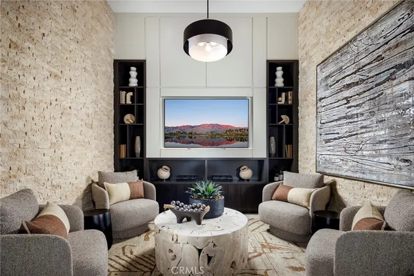 a living room with furniture a rug and a wall painting