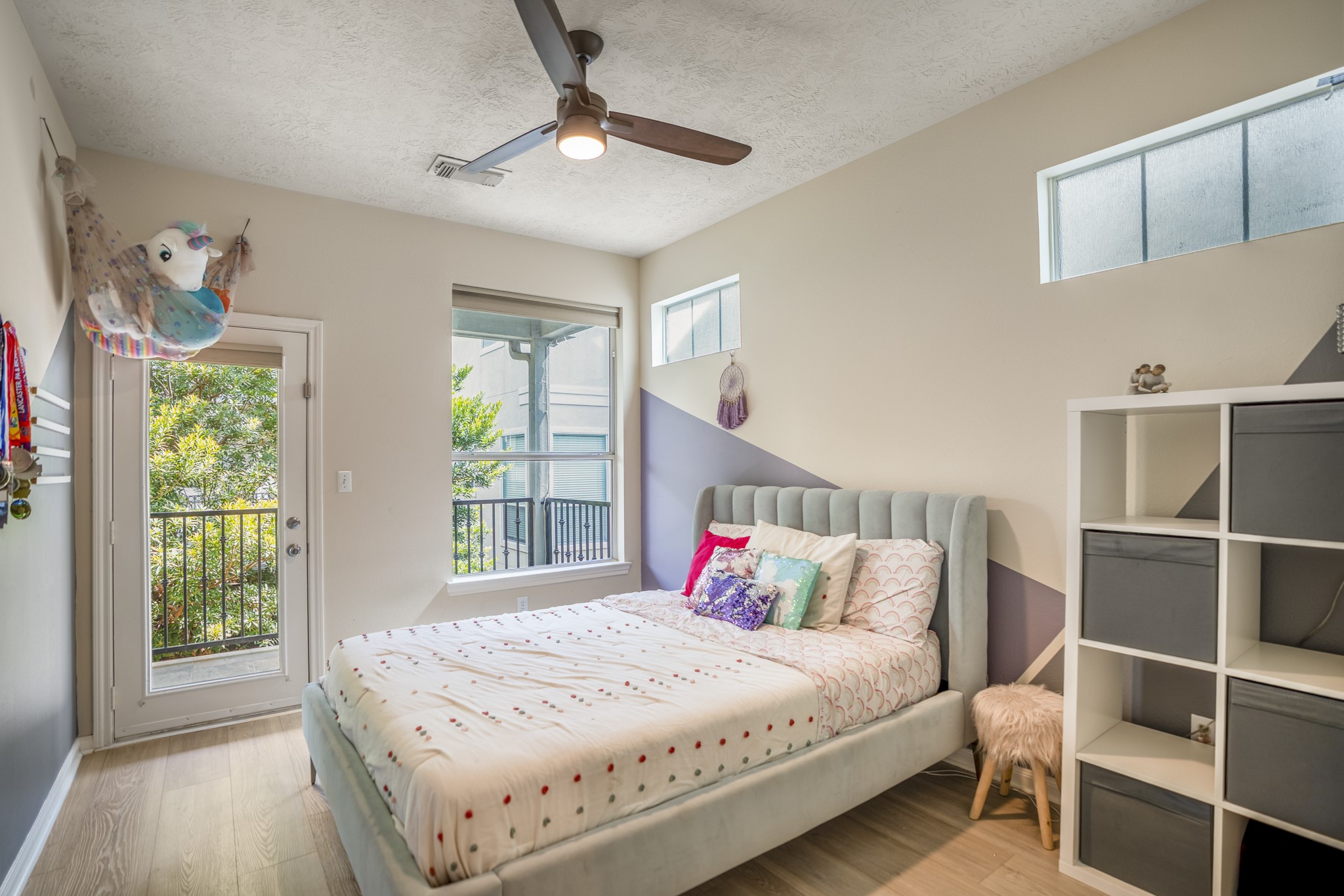 4236 Drake Street Houston, TX 77005 - Photo 25 of 43 The other second floor bedroom, also with private balcony access, creates a bright and inviting retreat, complete with a generous closet.