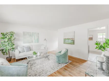 a living room with furniture and flowers