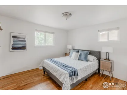 a bed with a white comforter and pillows