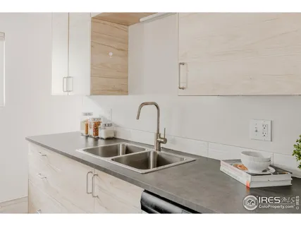 a kitchen with sink and cabinets