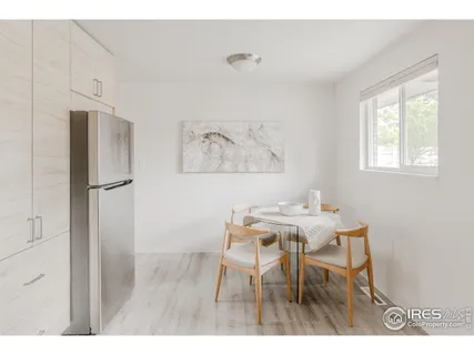 a view of a dining room with furniture and a window