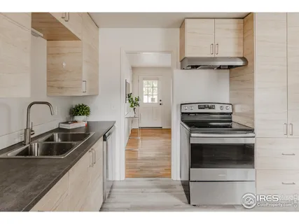 a kitchen with cabinets a sink and stainless steel appliances