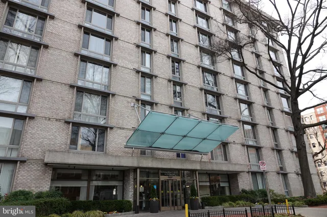a front view of a building with glass windows and a table
