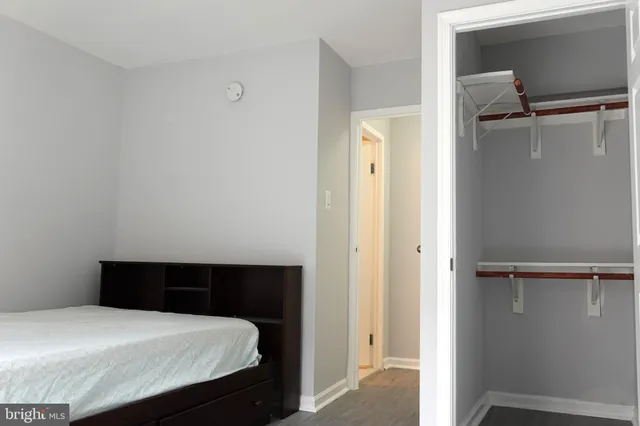 a bedroom with a bed and a closet