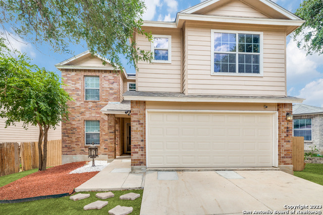 9606 San Fidel Rio San Antonio, TX 78245 - Photo 1 of 1 a front view of a house with a yard and garage