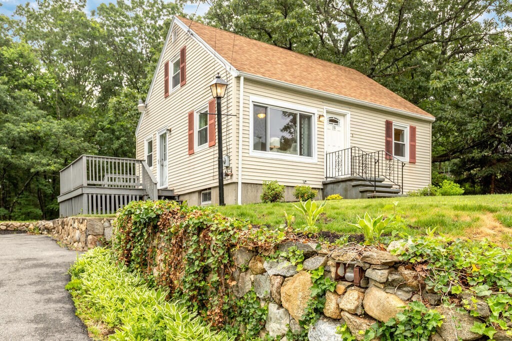 18 Woodbury Road Billerica, MA 01821 - Photo 1 of 30 a view of a white house with large windows and flower plants