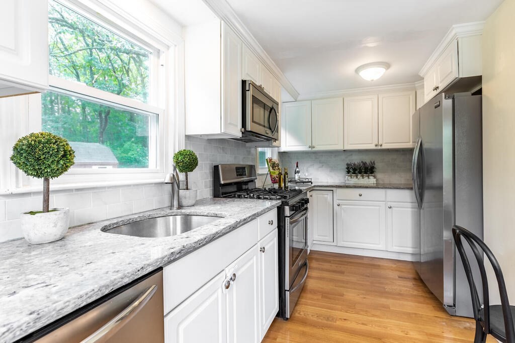 18 Woodbury Road Billerica, MA 01821 - Photo 14 of 30 a kitchen with granite countertop a sink stainless steel appliances and cabinets