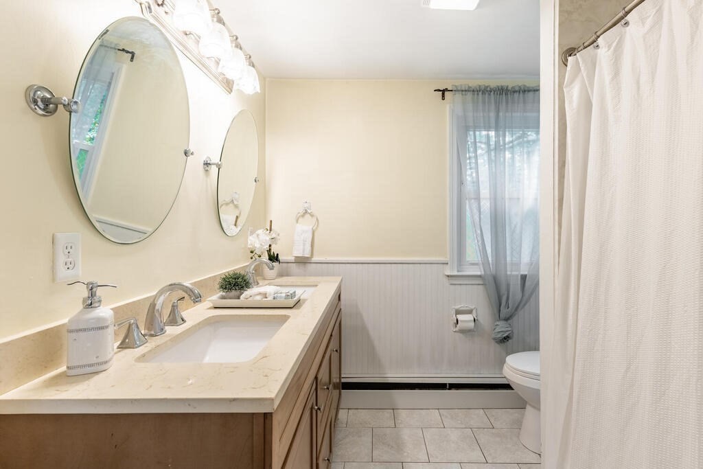18 Woodbury Road Billerica, MA 01821 - Photo 20 of 30 a bathroom with a sink and a mirror