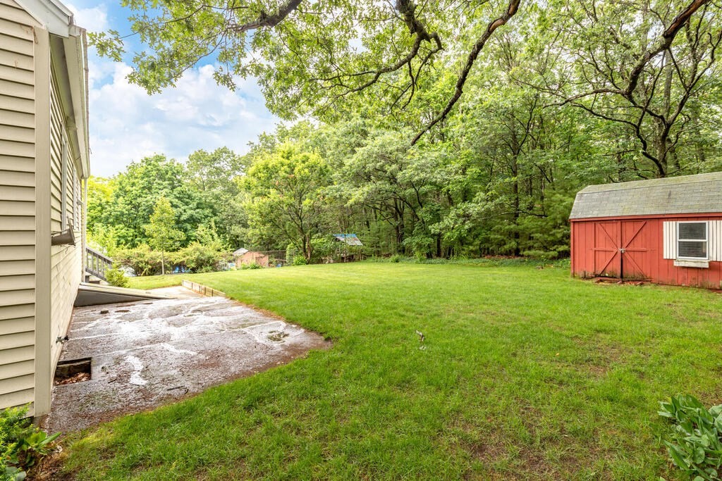 18 Woodbury Road Billerica, MA 01821 - Photo 27 of 30 a view of a yard with plants and large trees