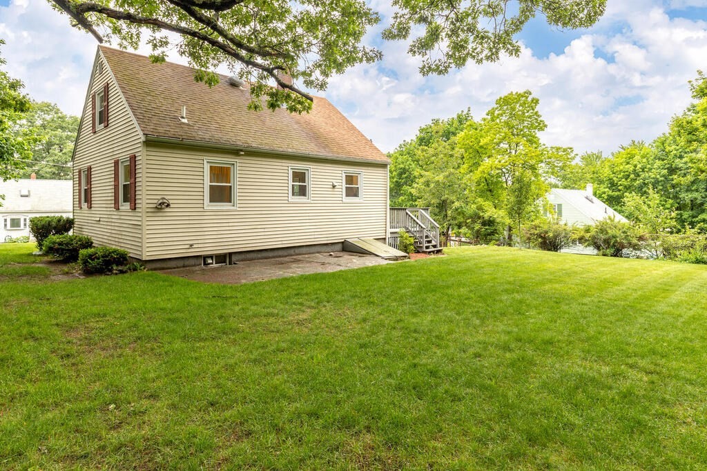 18 Woodbury Road Billerica, MA 01821 - Photo 29 of 30 a front view of house with yard and trees in the background