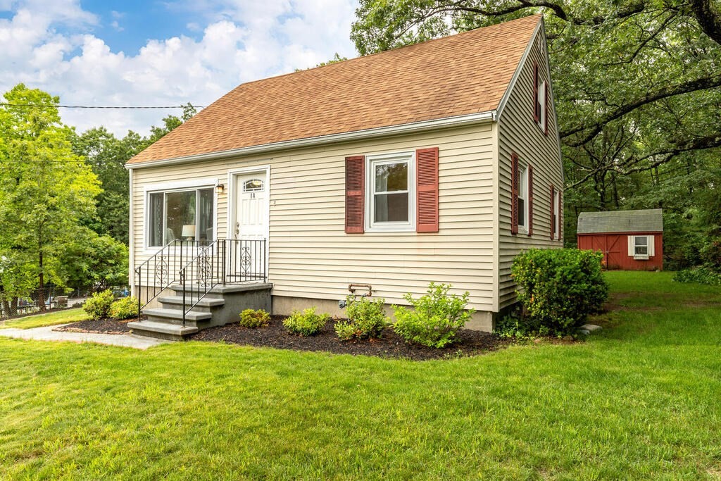 18 Woodbury Road Billerica, MA 01821 - Photo 3 of 30 a view of a house with a yard and plants