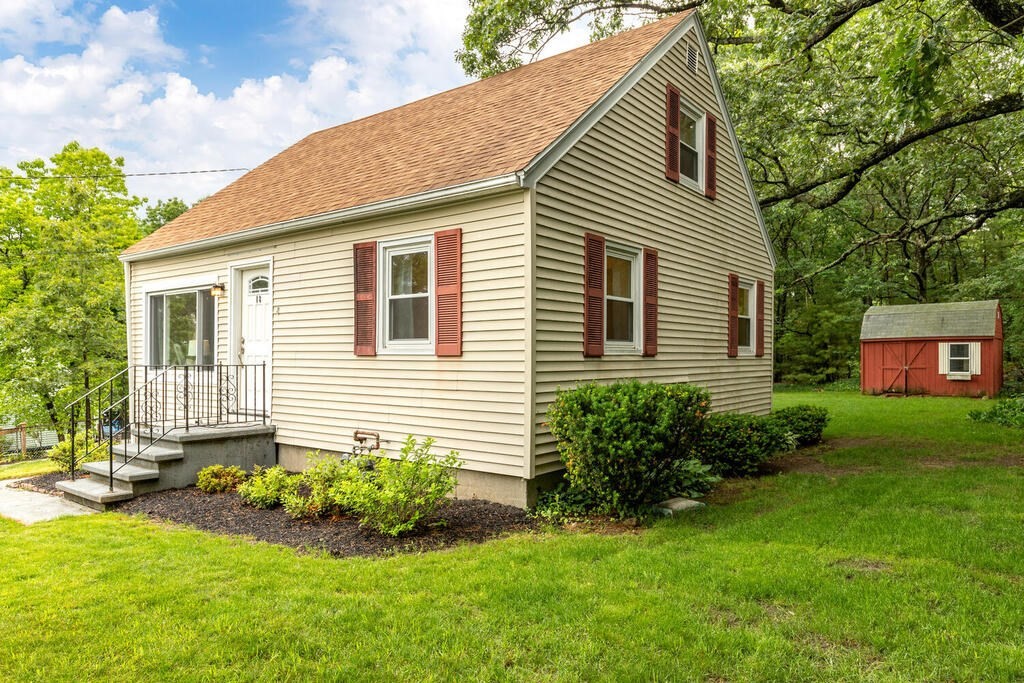18 Woodbury Road Billerica, MA 01821 - Photo 4 of 30 a front view of a house with a yard and outdoor seating