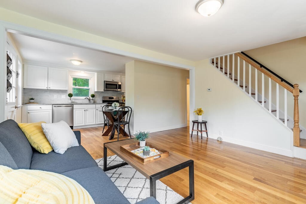 18 Woodbury Road Billerica, MA 01821 - Photo 8 of 30 a living room with furniture and a dining table with wooden floor