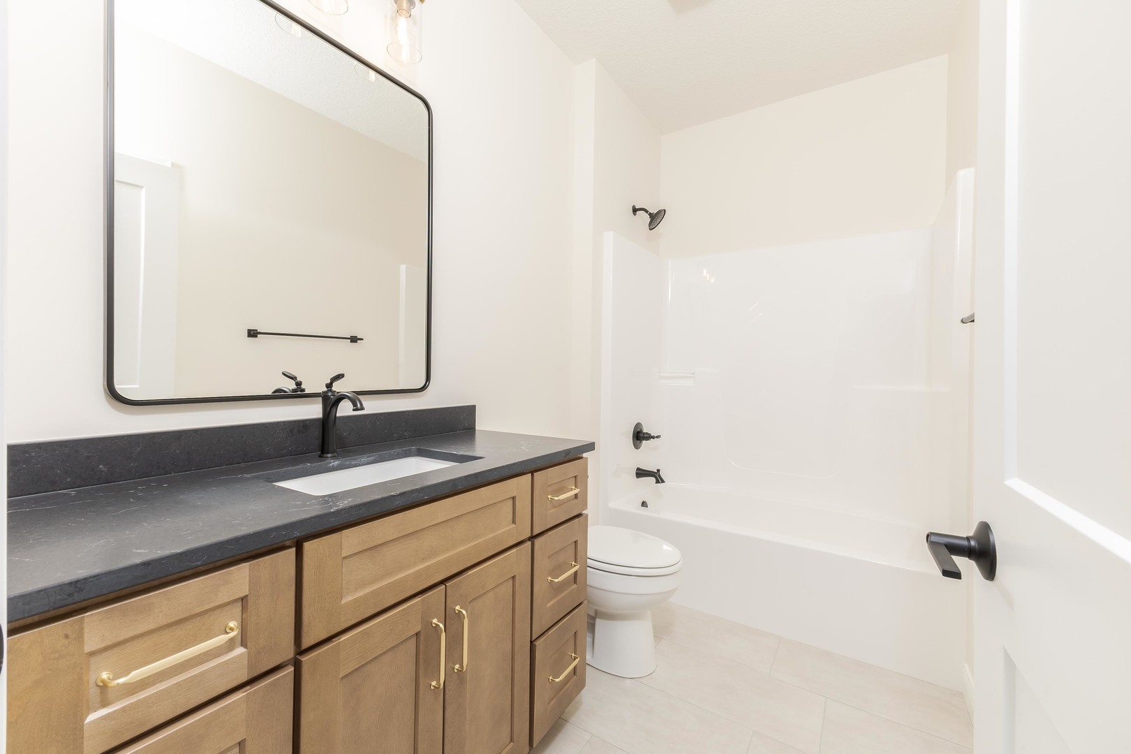 2538 Marble Road Normal, IL 61761 - Photo 8 of 27 a bathroom with a granite countertop sink a toilet and a mirror