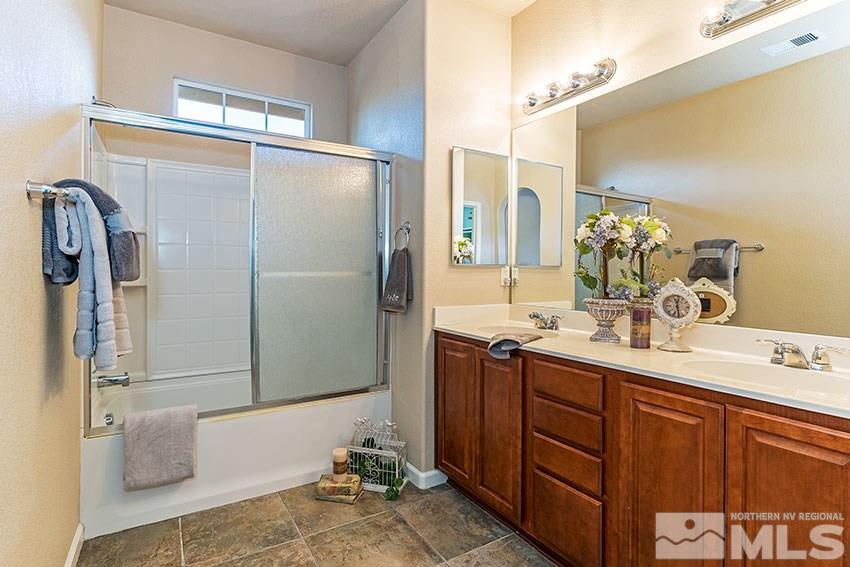 1815 Stetson Drive Reno, NV 89521 - Photo 12 of 20 a bathroom with a granite countertop sink and a mirror