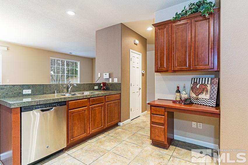 1815 Stetson Drive Reno, NV 89521 - Photo 3 of 20 a kitchen with stainless steel appliances granite countertop a sink stove and cabinets