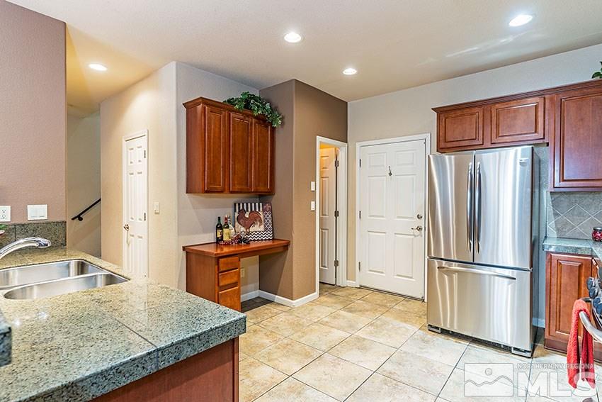 1815 Stetson Drive Reno, NV 89521 - Photo 4 of 20 a kitchen with granite countertop a refrigerator and a sink