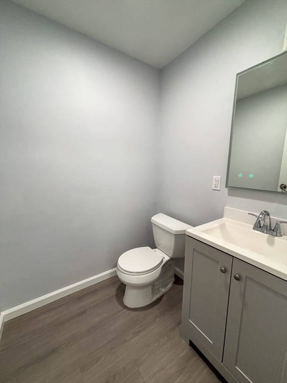 505 Washington, Unit 46 Chelsea, MA 02150 - Photo 11 of 16 a bathroom with a toilet a sink and mirror