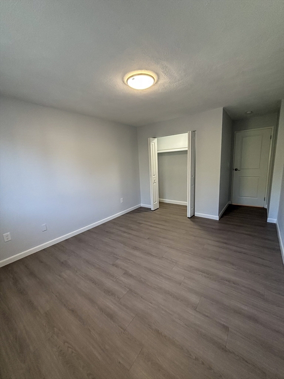 505 Washington, Unit 46 Chelsea, MA 02150 - Photo 14 of 16 a view of an empty room with wooden floor