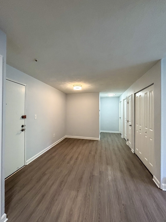 505 Washington, Unit 46 Chelsea, MA 02150 - Photo 5 of 16 a view of an empty room with wooden floor