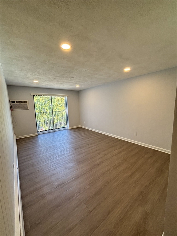 505 Washington, Unit 46 Chelsea, MA 02150 - Photo 7 of 16 an empty room with wooden floor and window