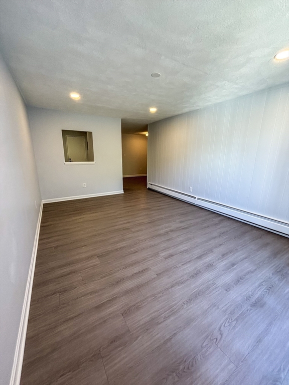 505 Washington, Unit 46 Chelsea, MA 02150 - Photo 8 of 16 a view of an empty room with wooden floor and a window