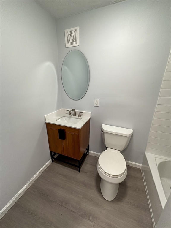 505 Washington, Unit 46 Chelsea, MA 02150 - Photo 10 of 16 a bathroom with a toilet sink and mirror