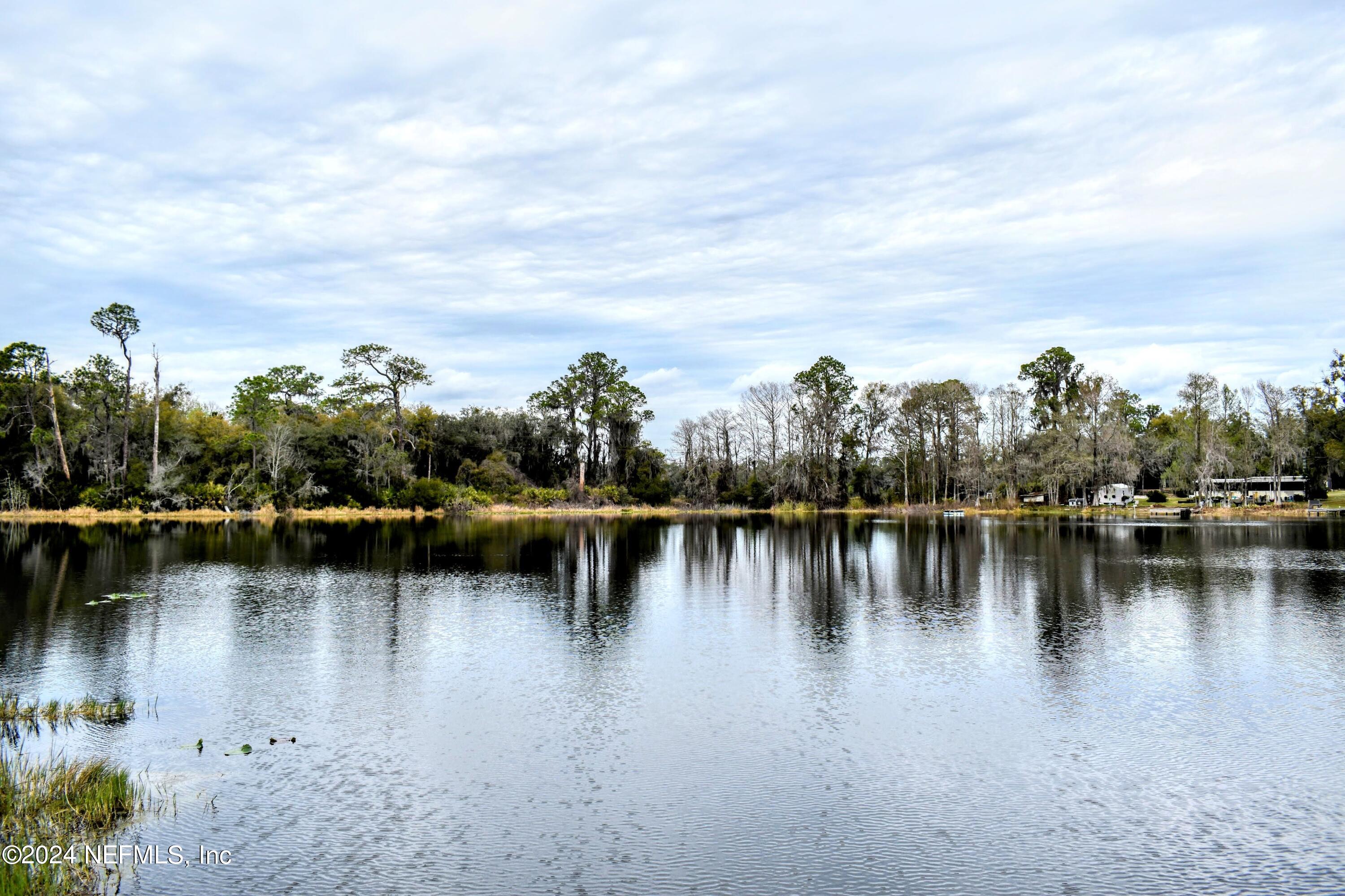 112 Hanson Road Interlachen, FL 32148 - Photo 2 of 13 a view of a lake with boats and trees in the background