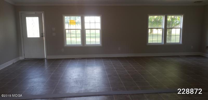 448 Scott Road Elko, GA 31025 - Photo 4 of 13 an empty room with wooden floor and windows