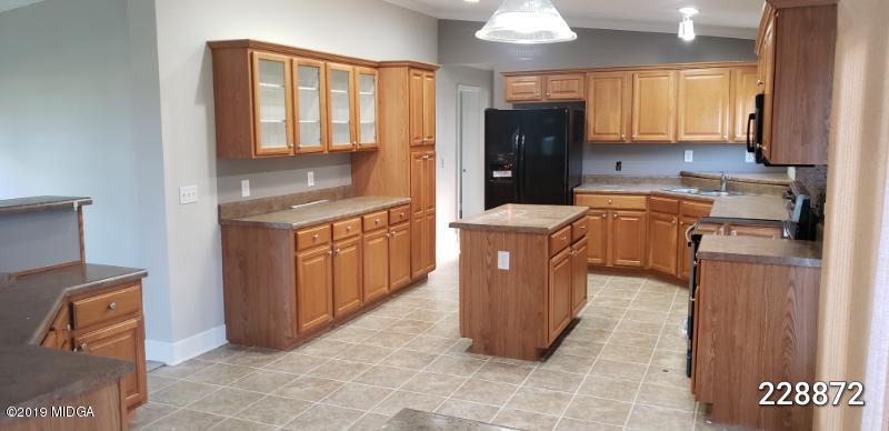448 Scott Road Elko, GA 31025 - Photo 6 of 13 a kitchen with stainless steel appliances granite countertop a stove top oven a sink a refrigerator and cabinets