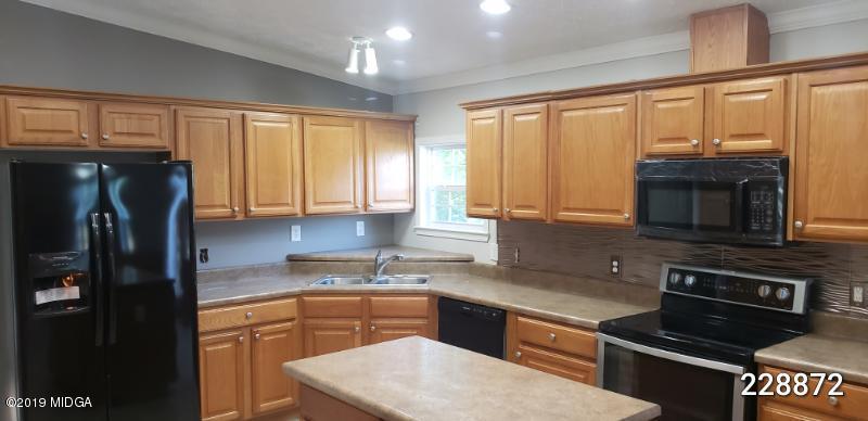 448 Scott Road Elko, GA 31025 - Photo 7 of 13 a kitchen with stainless steel appliances granite countertop a refrigerator stove and sink