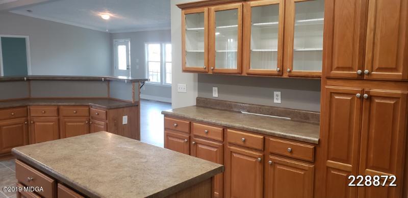 448 Scott Road Elko, GA 31025 - Photo 8 of 13 a kitchen with stainless steel appliances granite countertop a sink a stove and a microwave